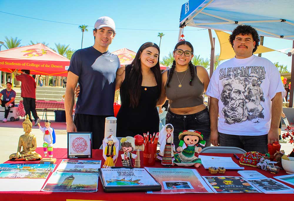 Students smiling at an outdoor campus event