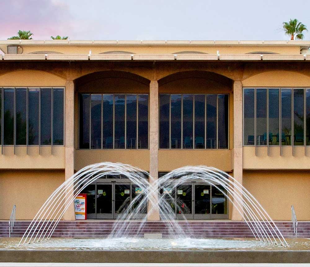 Exterior view of a campus building with fountains
