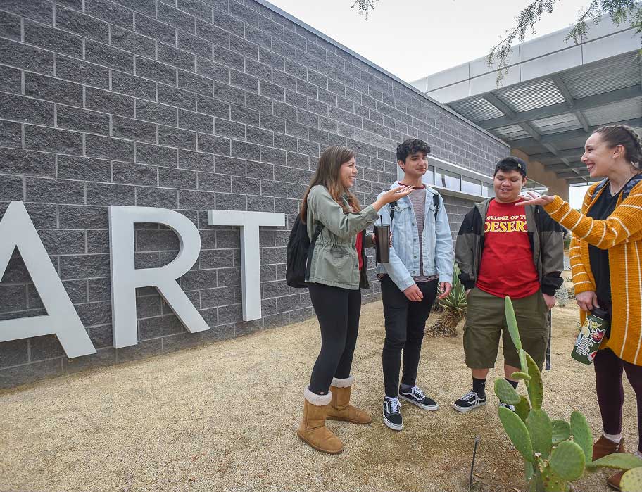 Students presenting at an art exhibit